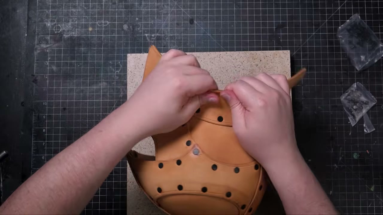 Warrior Helmet Build Guide: A Real Leather Helmet with Just a Hammer 13 Riveting the flared tail piece around the helmet's rear edge