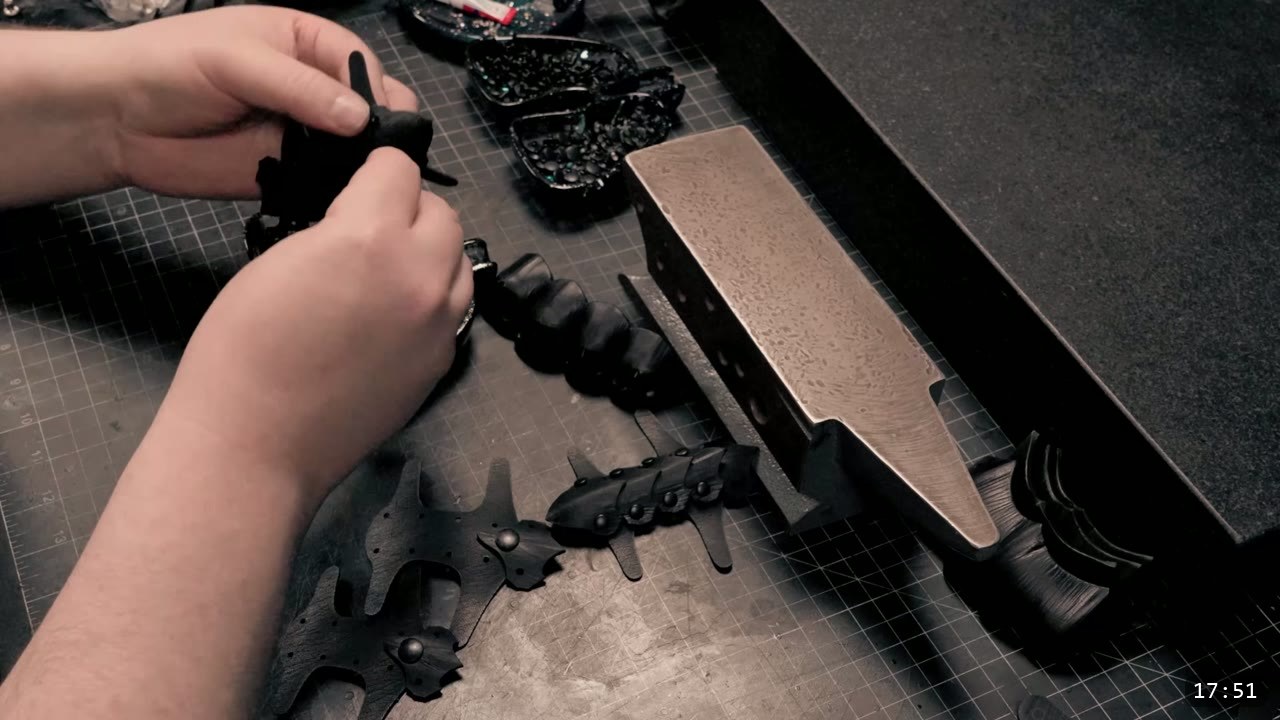 Berserk Gauntlets Build Guide: The Leather Version, Step by Step 14 a row of riveted black leather finger scales drawing toward a claw tip, beside a stone slab and forming blocks