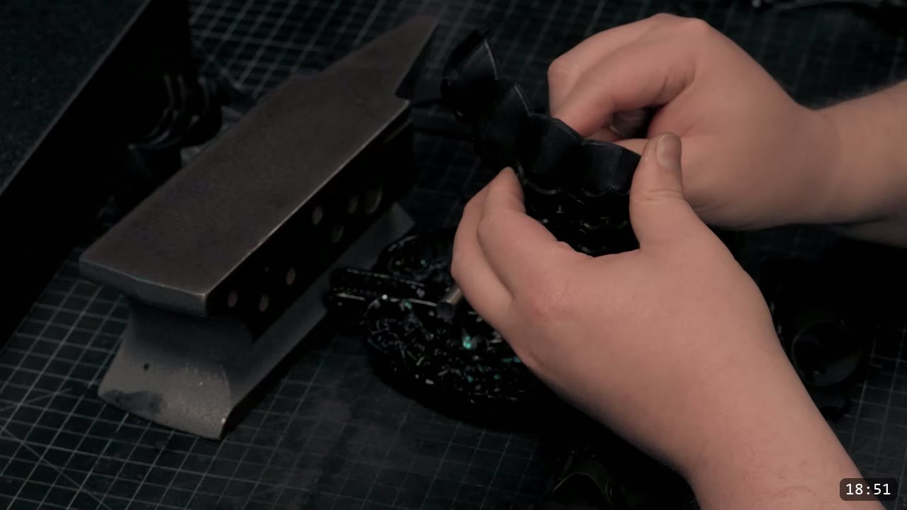 Berserk Gauntlets Build Guide: The Leather Version, Step by Step 15 hands shaping and setting a curved black fluted knuckle plate against a pointed mini anvil