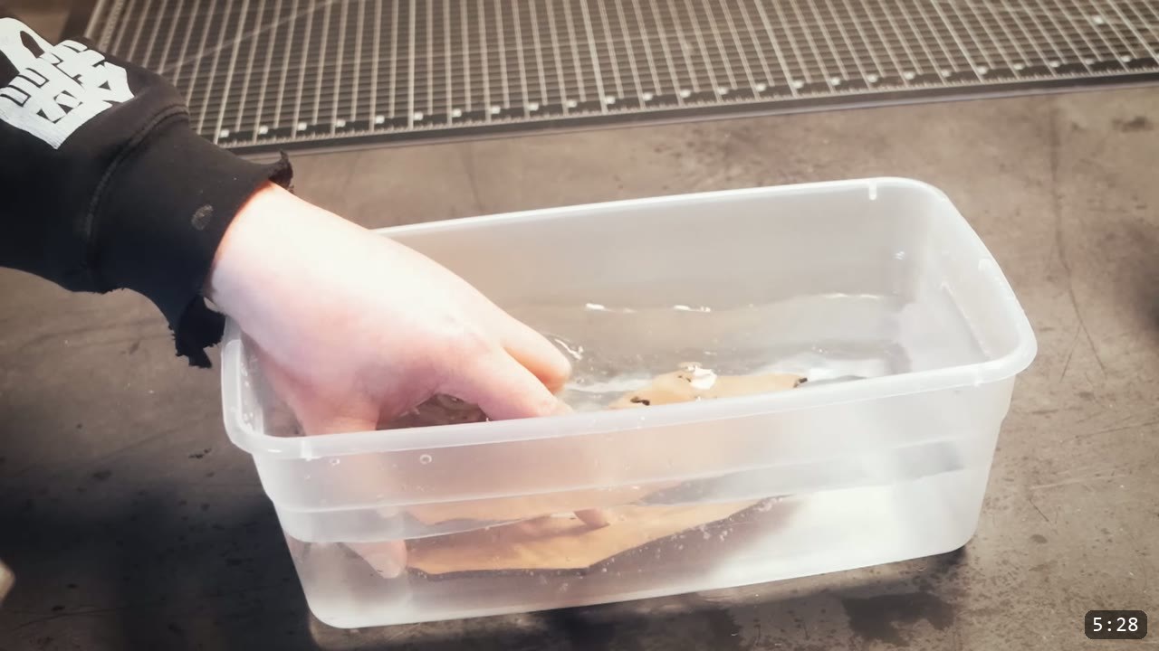 Berserk Gauntlets Build Guide: The Leather Version, Step by Step 5 a hand submerging cut vegetable-tan gauntlet pieces in a tub of water