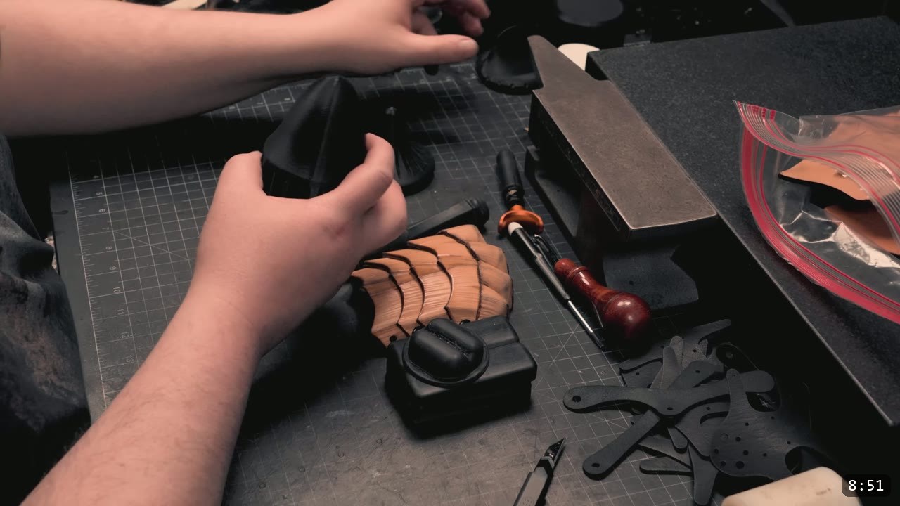 Berserk Gauntlets Build Guide: The Leather Version, Step by Step 8 black 3D-printed forming blocks on the bench beside a fluted tan finger plate and the airtight casing bag