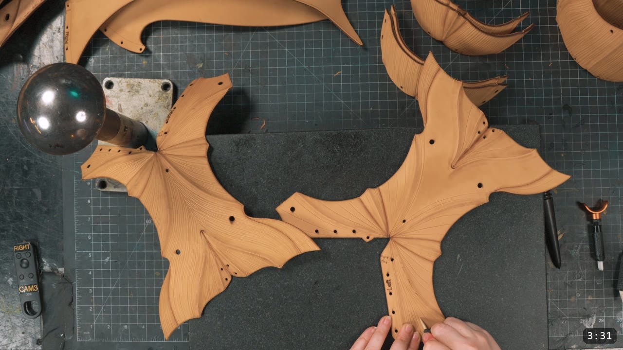 Berserk Leg Armor Build Guide: Articulated Leather Cuisses, Knees, and Greaves 3 Two vegetable tan upper leg pieces with radiating fluted crease lines, marked right and left, being detailed by hand next to a round metal stake