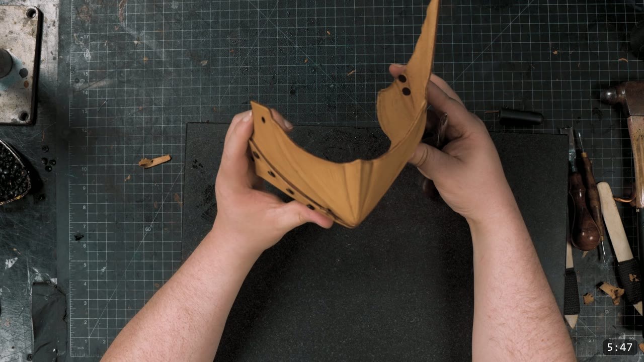 Berserk Leg Armor Build Guide: Articulated Leather Cuisses, Knees, and Greaves 4 Hands flexing a curved riveted natural leather knee guard into its final three dimensional shape