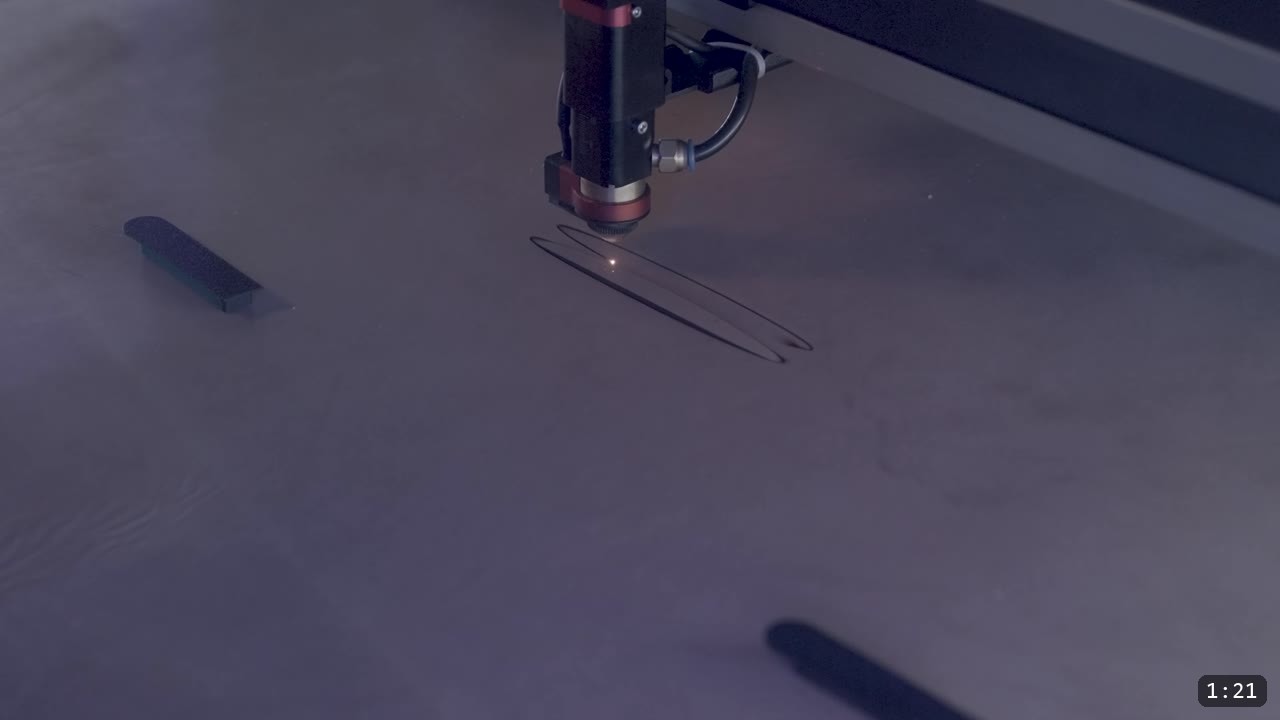 Berserk Leather Pauldrons Build Guide: Articulated Shoulder Armor from the Berserk Suit 3 a laser head cutting two small test ovals into a large sheet of leather on the machine bed