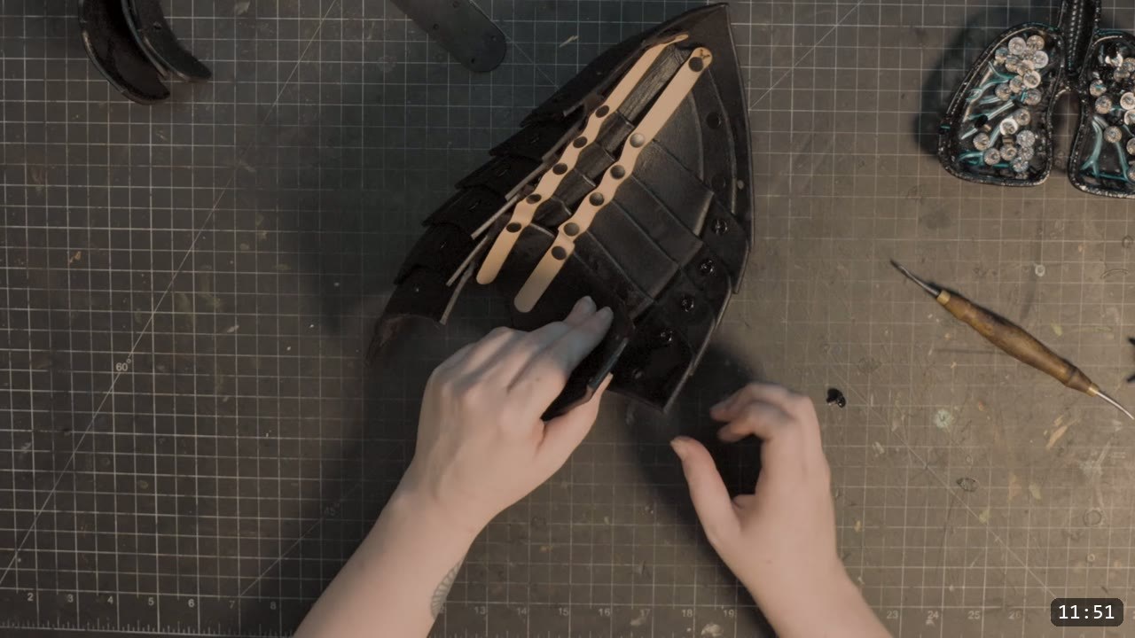 Leather Sabatons Build Guide: Berserk Foot Armor from a Flat Pattern 12 overhead view of the assembled black sabaton back with retaining straps threaded through the overlapping fluted plates