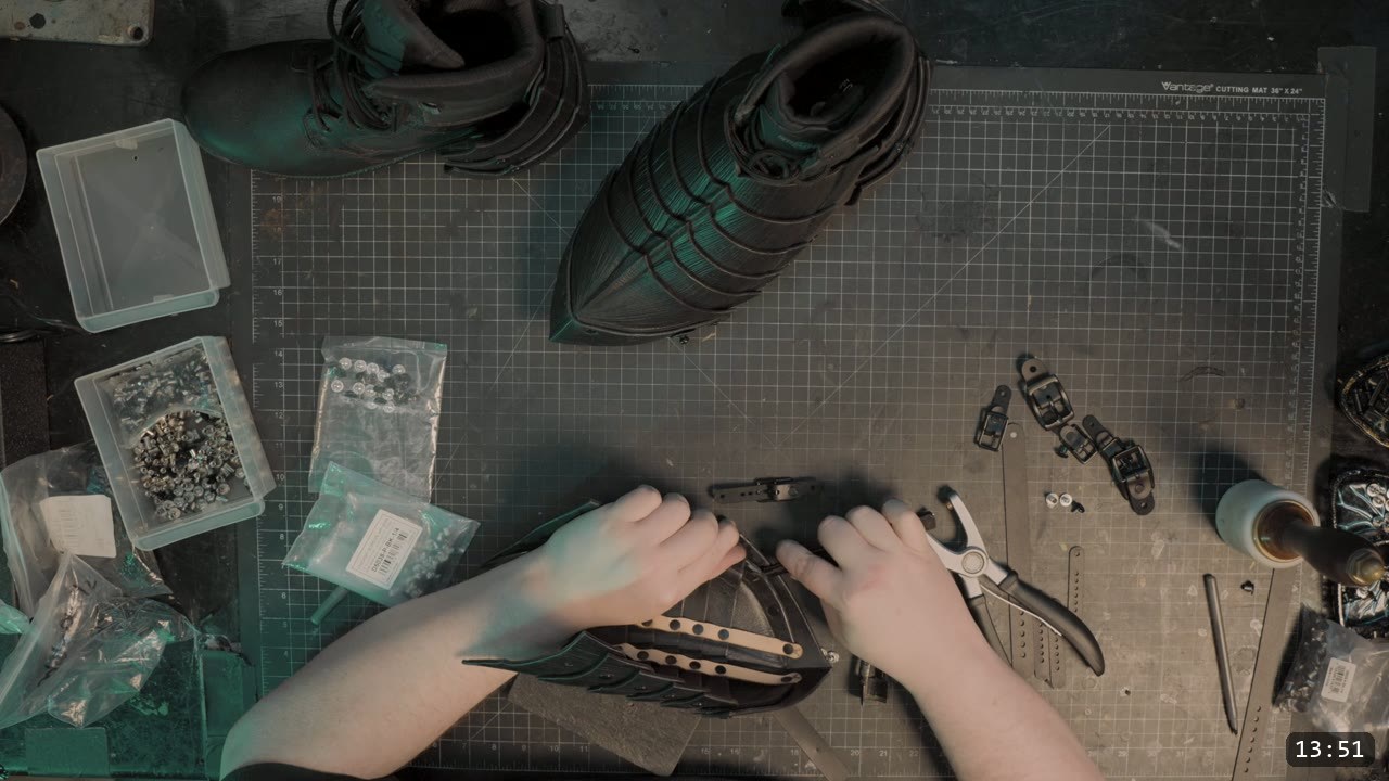 Leather Sabatons Build Guide: Berserk Foot Armor from a Flat Pattern 13 a finished black sabaton test-fitted next to a boot, with trays of Chicago screws, rivets, and snaps on the bench