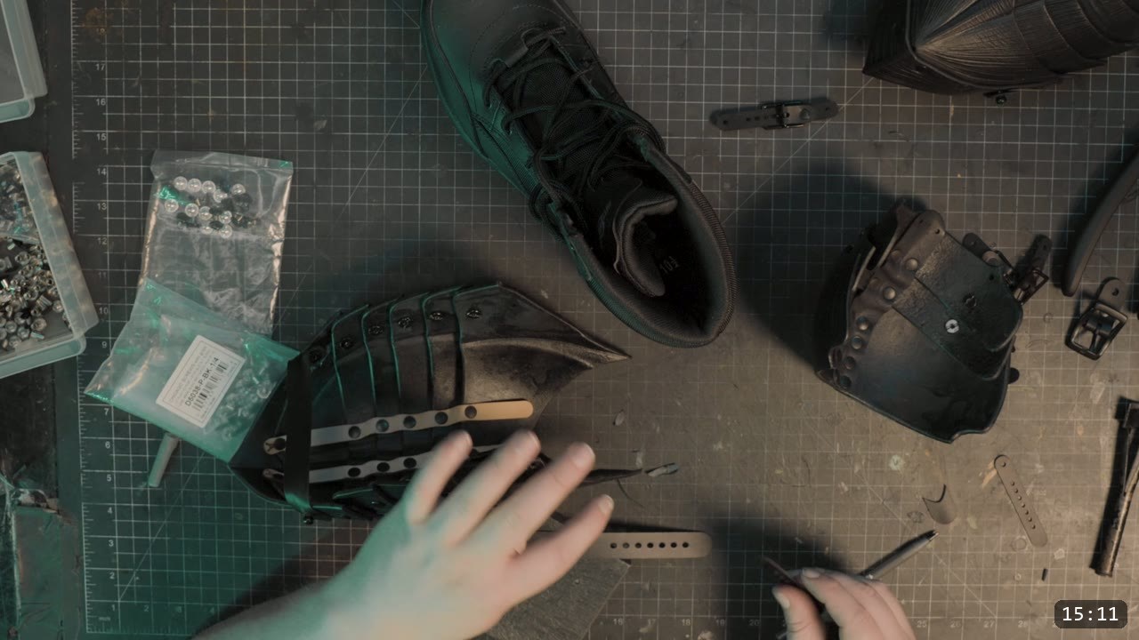 Leather Sabatons Build Guide: Berserk Foot Armor from a Flat Pattern 14 positioning a tan sacrificial strap on the black sabaton over a boot for fitting