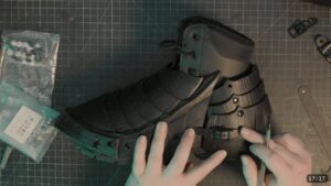 Roadmap Updates & Pre-Order Status 3 the finished black articulated sabaton fitted over a laced boot, with a side buckle strap and fluted overlapping plates