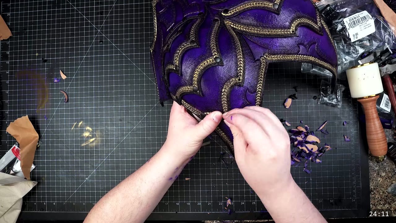 Female Leather Breastplate Build Guide: Articulated Fantasy Armor, Step by Step 3 a purple front breastplate piece with gold braided edge tooling, being riveted on a black cutting mat