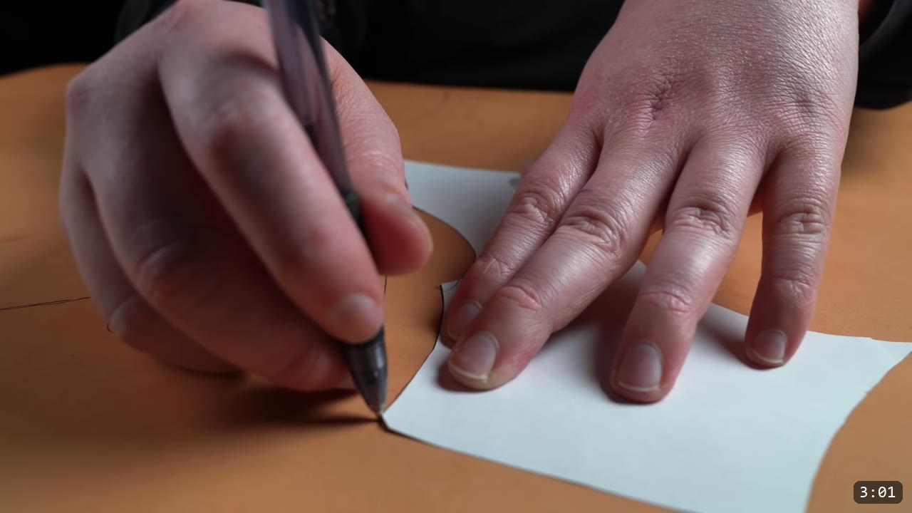 Female Leather Breastplate Build Guide: Articulated Fantasy Armor, Step by Step 4 tracing a paper pattern piece onto tan vegetable-tan leather with a ballpoint pen