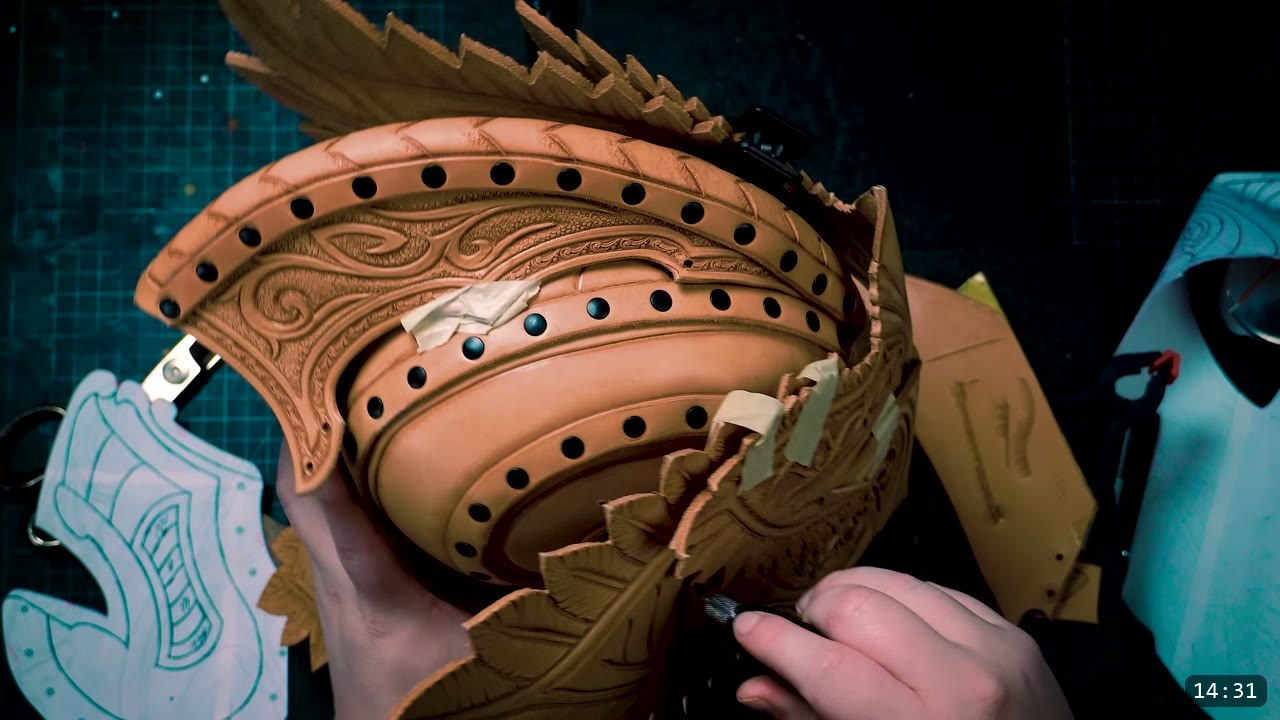 Leather Elven Helmet Build Guide: Visor, Comb, Tail, and a Green Metallic Finish 8 a tooled brow and visor band with feathered plates taped in position to check the pivot fit, a paper pattern piece resting at the lower left