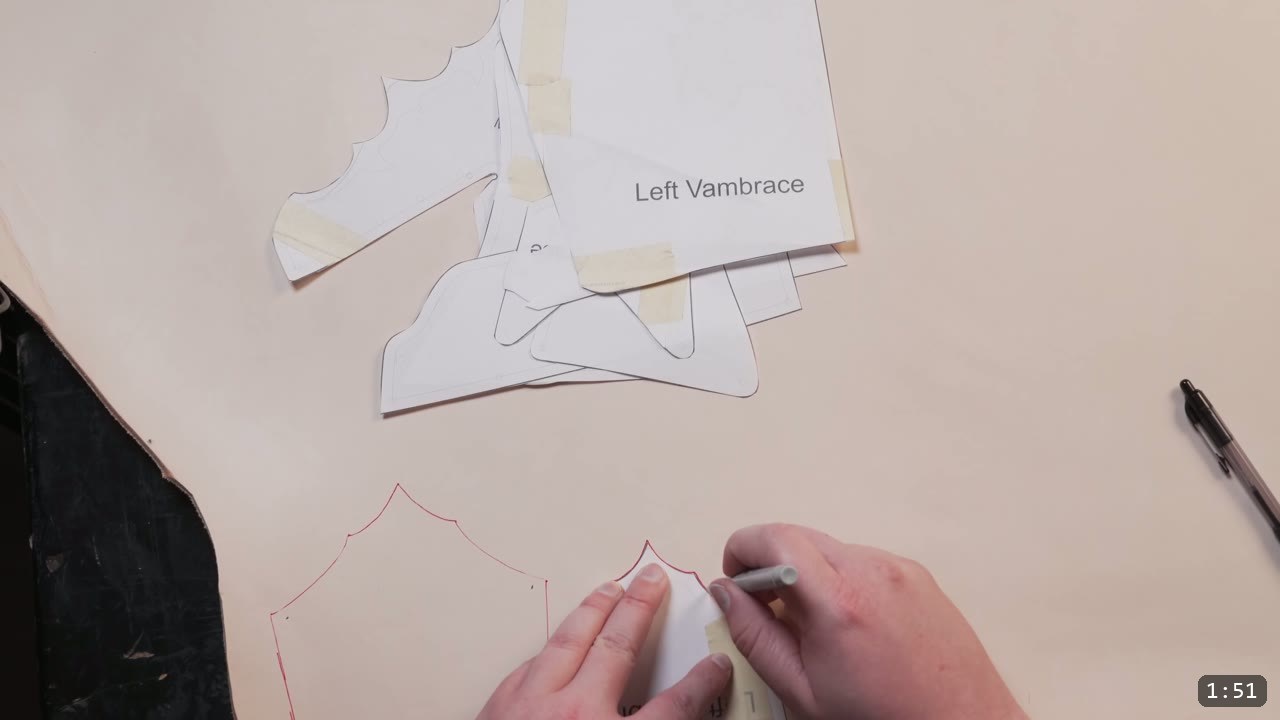 Leather Arm Armor Build Guide: Fantasy Vambrace, Rerebrace, and Elbow 3 a paper pattern piece labeled Left Vambrace with the arm-armor shapes, tracing another piece onto leather in red marker by hand