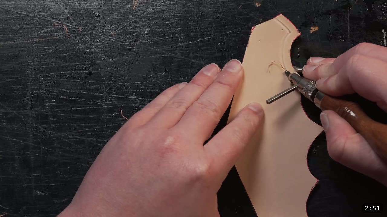 Leather Arm Armor Build Guide: Fantasy Vambrace, Rerebrace, and Elbow 5 cutting a decorative line into the barbed edge of a tan elbow piece with a hand tool