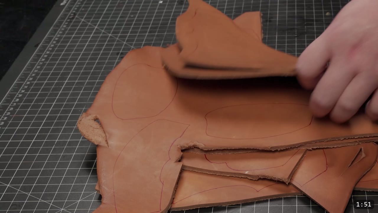 Articulating Leather Gauntlets Build Guide: A Fantasy Set from a Flat Pattern 2 cut tan vegetable-tan gauntlet cuff and hand pieces with red transferred design lines on a cutting mat, hands separating them