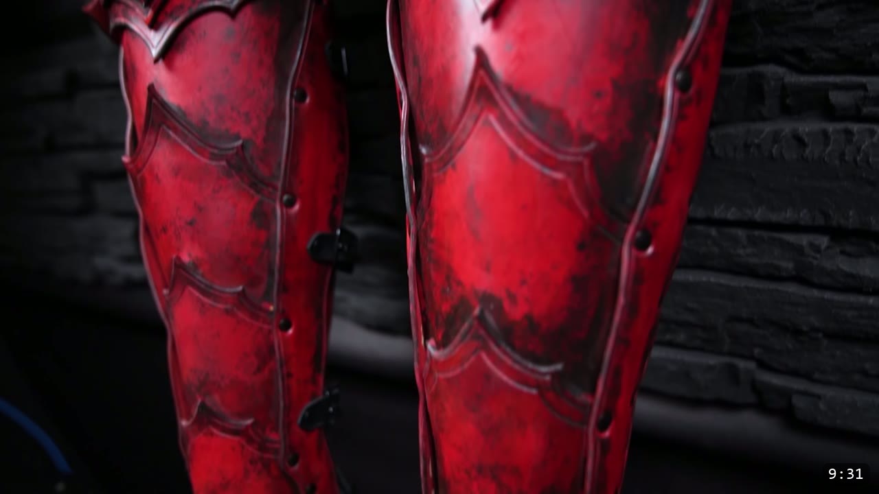 Leather Cuisses and Knees Build Guide: Articulated Upper-Leg Armor 13 two finished red leather cuisses with black weathering, scalloped scale-plate borders, and rivets standing against dark stone