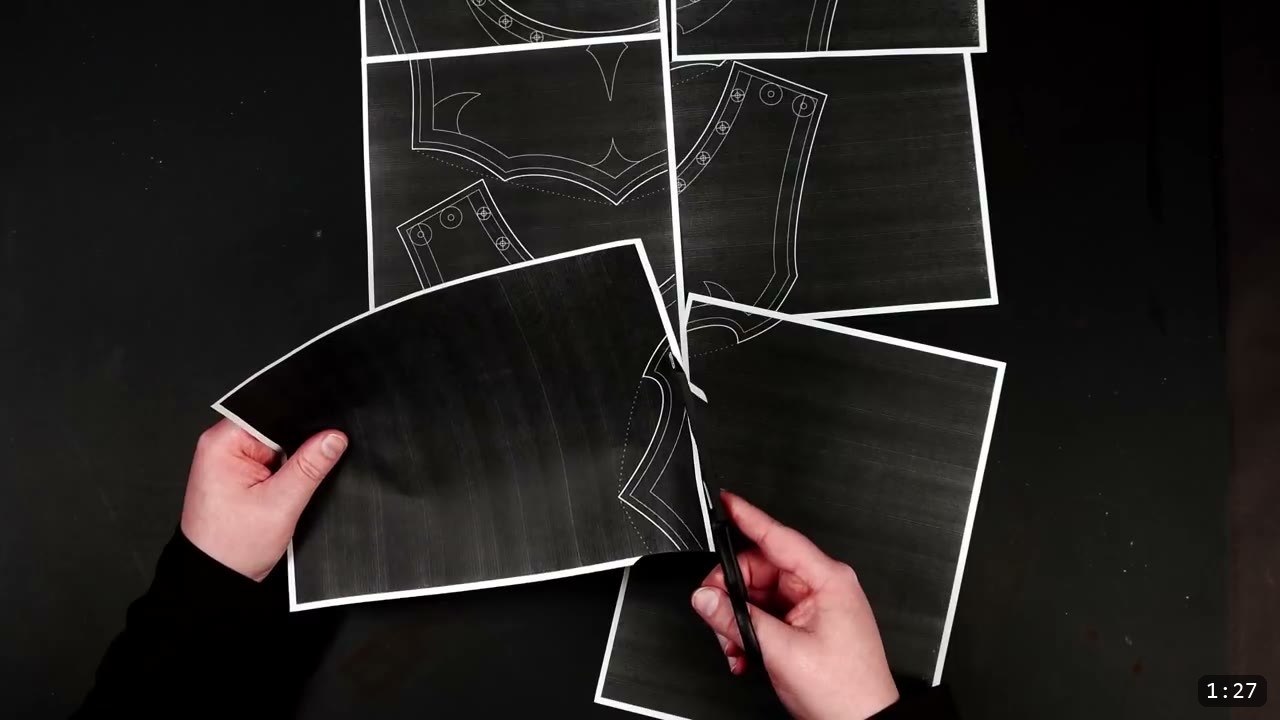Leather Gorget Build Guide: A Fantasy Armor Neck Guard, Step by Step 3 printed black pattern pages for the gorget laid out on a dark bench, hole positions marked, two pages held in hand