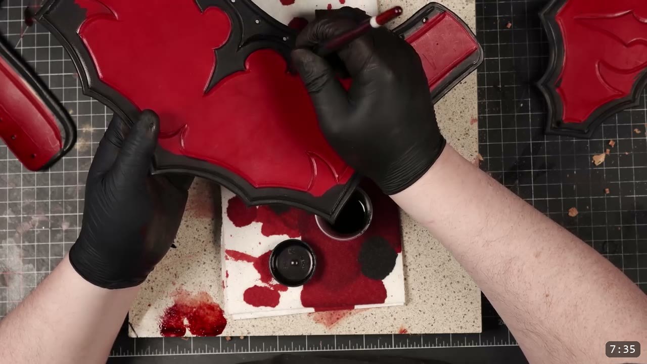 Leather Gorget Build Guide: A Fantasy Armor Neck Guard, Step by Step 10 a small brush laying black dye along the tooled borders of the red-dyed gorget front plate over a dish of black dye