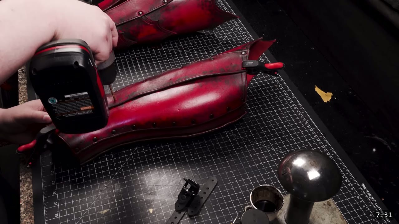 Leather Greaves Build Guide: From Flat Pattern to Antiqued Leg Armor 13 drilling a buckle hole through the assembled red greave with a cordless drill