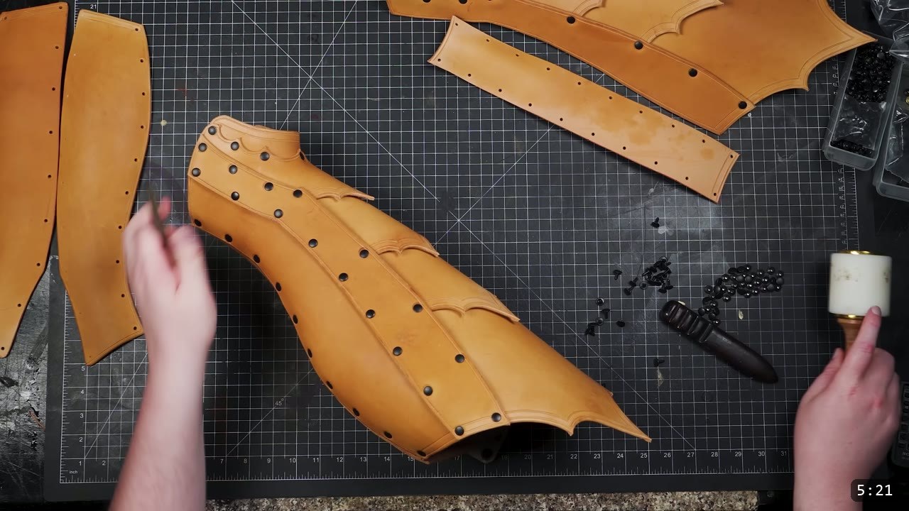 Leather Greaves Build Guide: From Flat Pattern to Antiqued Leg Armor 9 a partly assembled greave curving into a three-dimensional shape, rivets set along the seams and a scalloped tooled border along the edge
