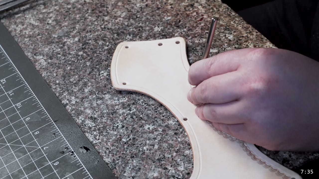 Leather Sabatons Build Guide: Foot Armor from a Flat Pattern 9 a tooled sabaton plate with a row of punched holes along the top edge and a scalloped border, an awl marking the next hole
