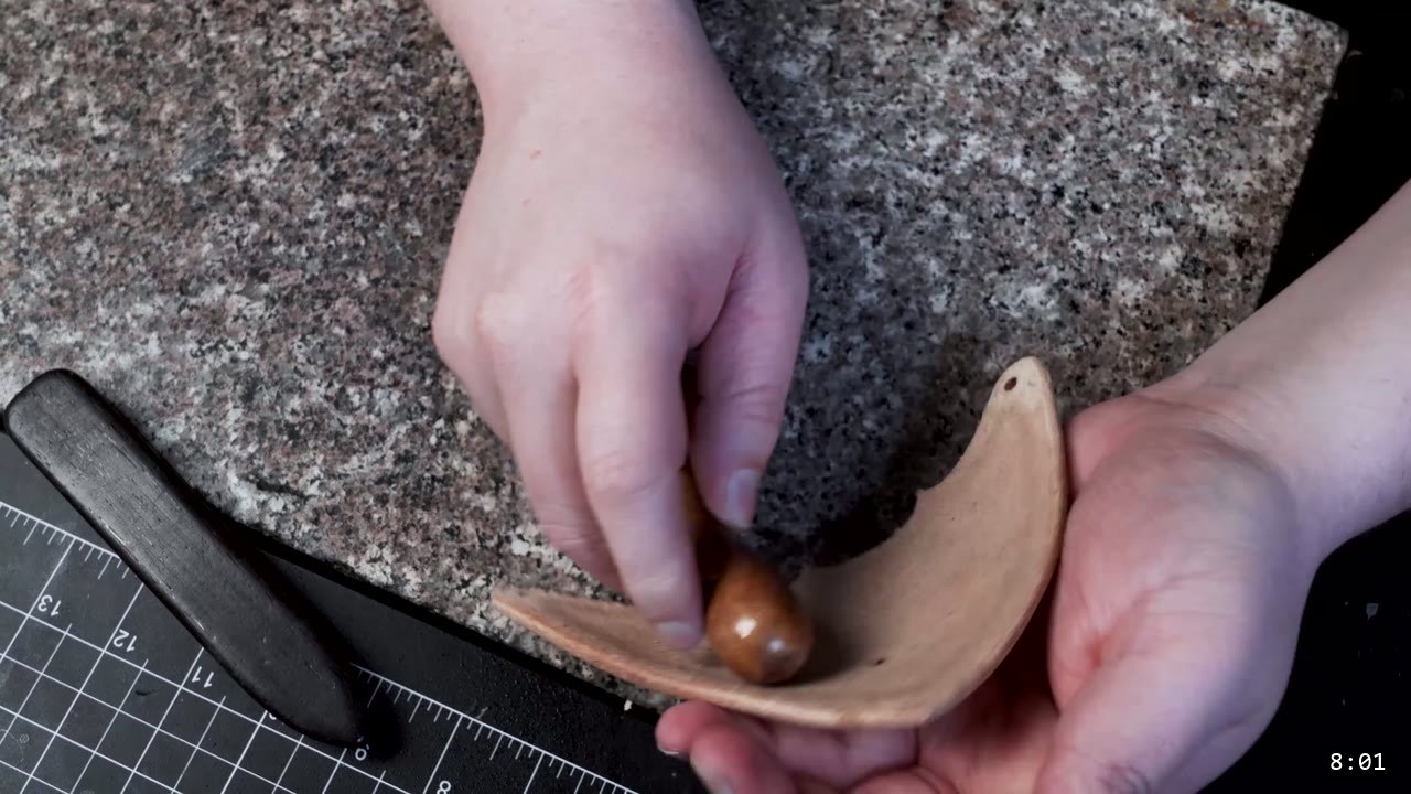 Leather Sabatons Build Guide: Foot Armor from a Flat Pattern 10 shaping a damp leather toe cap by stretching it over the rounded end of a wooden tool on a granite slab