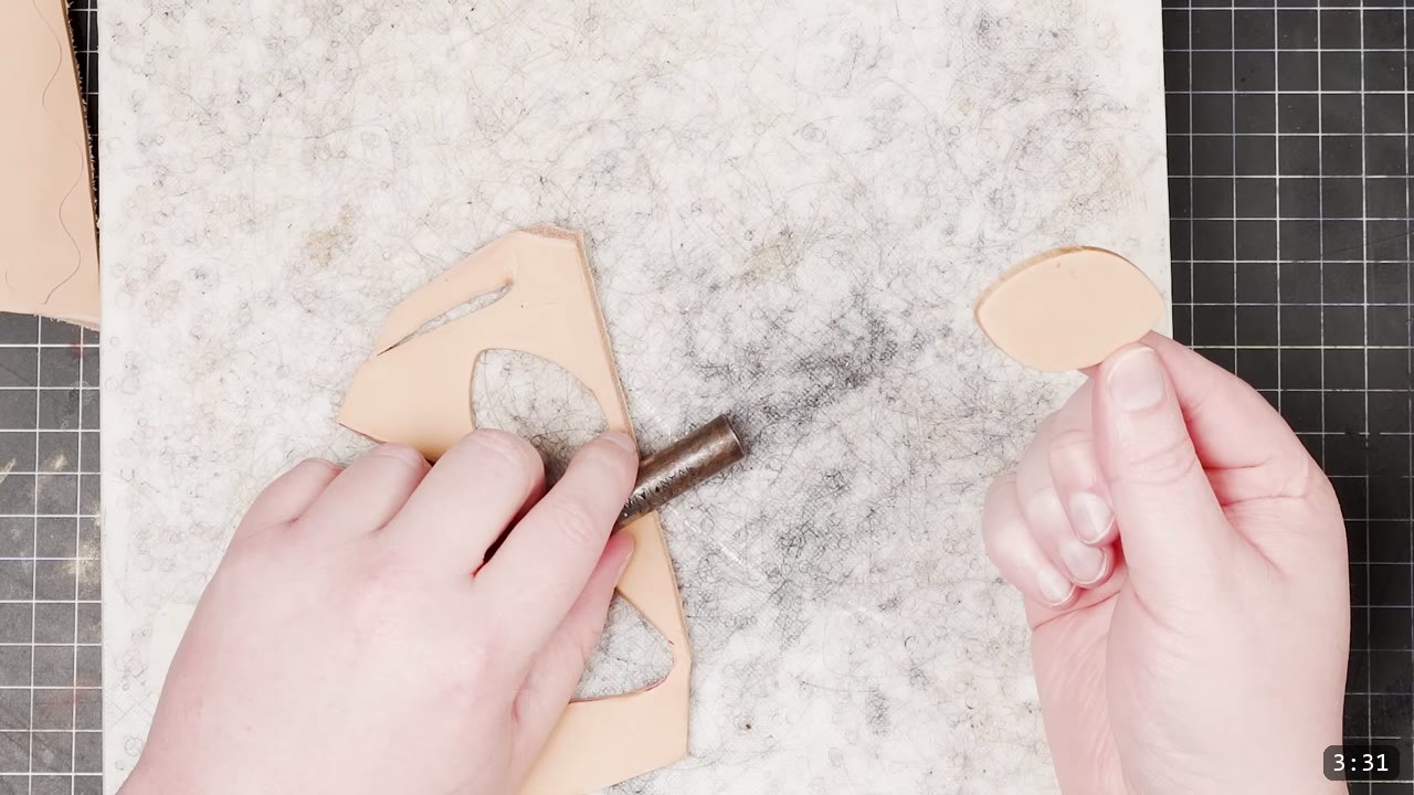 Leather Scale Armor Build Guide: A Flexible Scale Skirt from Scrap Leather 4 a strap-end punch pressed into tan veg-tan leather on a white poly board with a single cut scale held alongside
