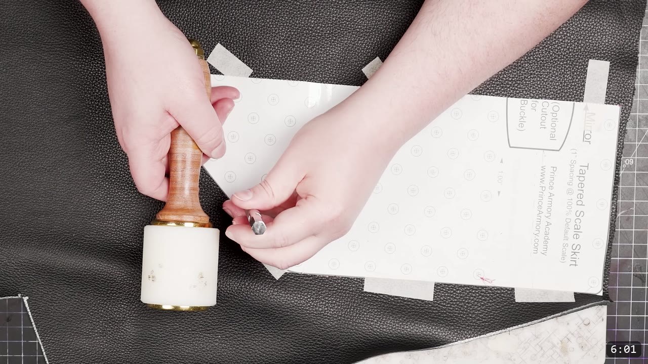 Leather Scale Armor Build Guide: A Flexible Scale Skirt from Scrap Leather 7 a white mallet and drive punch working rivet holes through the scale skirt pattern taped onto black backing leather