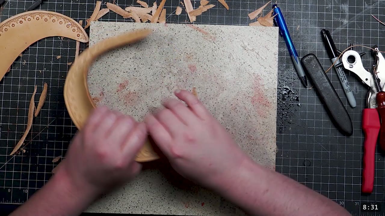 Fantasy Spaulders, Full Suit Version: Leather Shoulders That Mount to the Breastplate 8 hands stretching and forming a damp curved trim strip over the sharp edge of a granite slab, a tooled plate with a punched border resting to the left