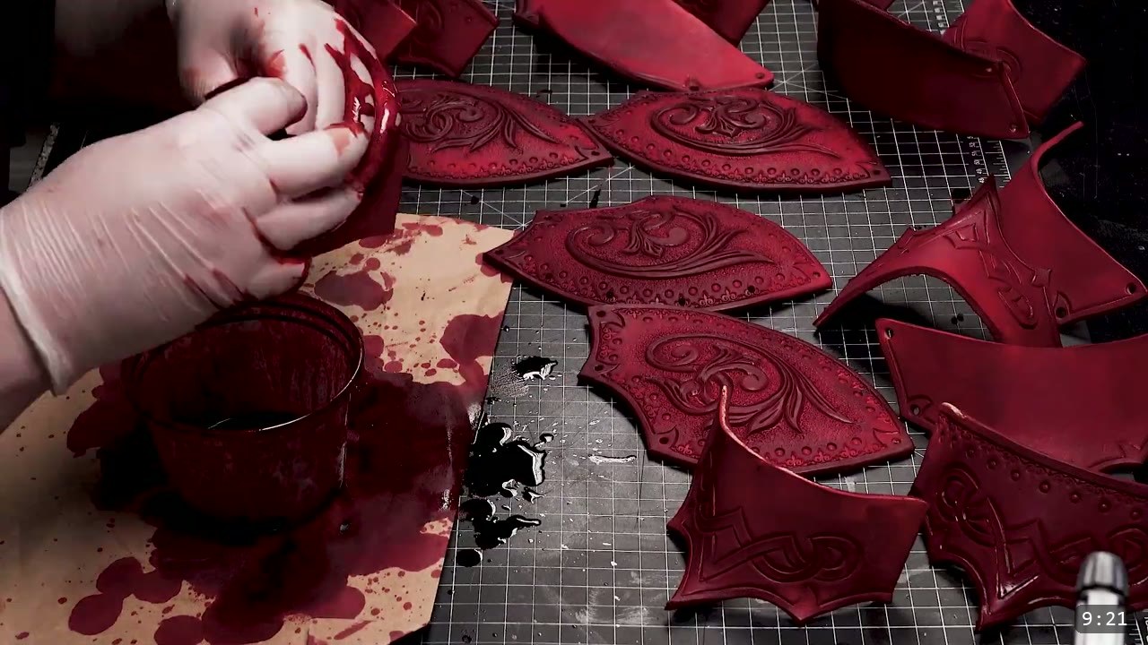 Fantasy Spaulders, Full Suit Version: Leather Shoulders That Mount to the Breastplate 9 a gloved hand sponging deep red dye onto tooled spaulder plates, several already-dyed oxblood plates and a cup of red dye laid out on the cutting mat