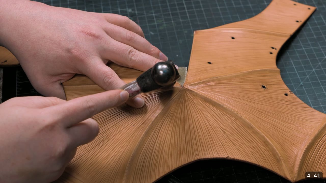 Finishing the Leather Berserk Armor: The Breastplate and Tassets Build Guide 6 refining the fluted striation lines on a tan leather panel by hand with a rounded modeling tool