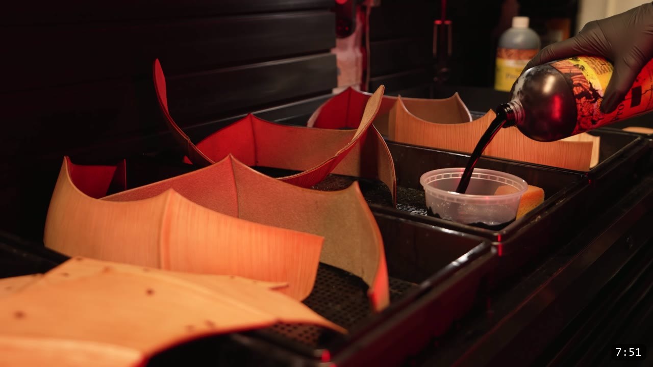 Finishing the Leather Berserk Armor: The Breastplate and Tassets Build Guide 9 pouring dark oil dye into a cup beside trays of cut Berserk pieces waiting to be dyed