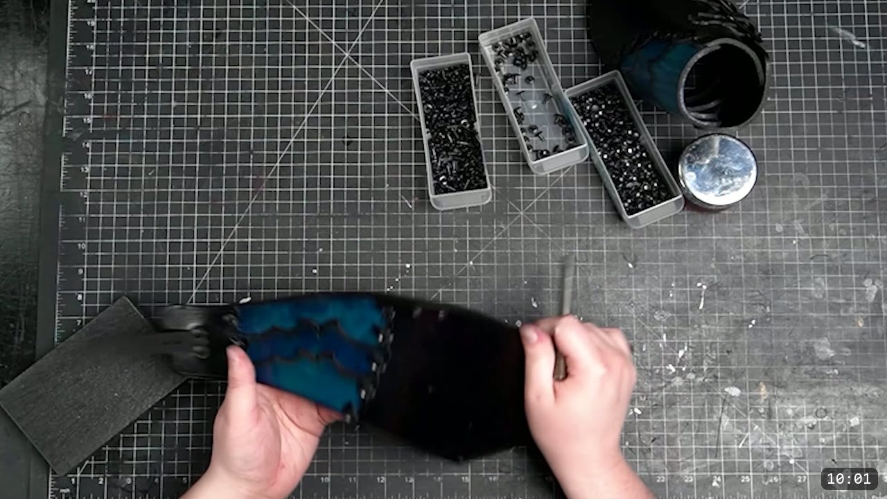 Articulated Leather Arm Armor Build Guide: The Imperial Knight Arms 12 hands connecting a dyed leather lame to the vambrace section with an awl, an assembled cannon nearby