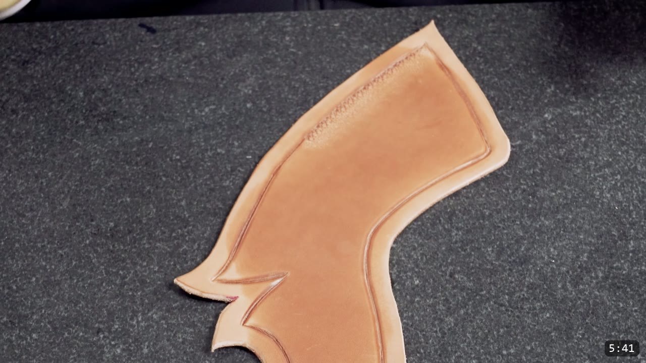 a cut corset piece on a granite slab showing a scored border line and a stamped texture band along the top edge