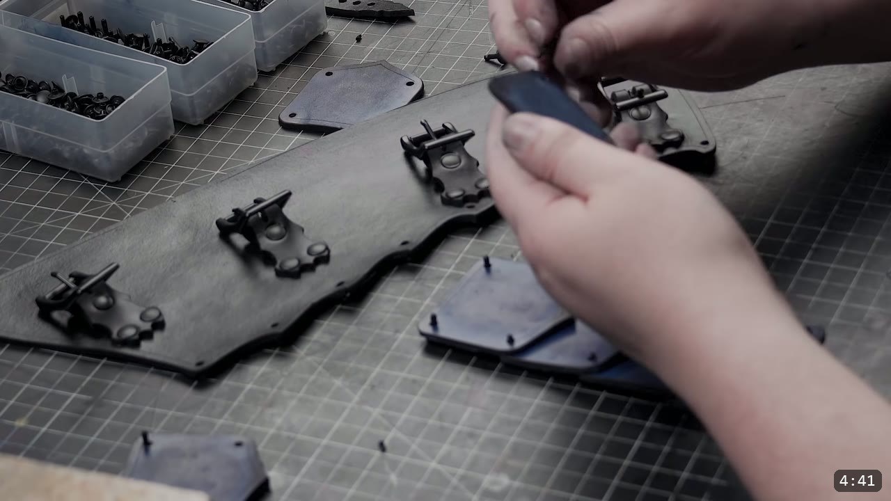 Leather Greaves Build Guide: Imperial Leg Armor from a Flat Pattern 6 a curved dark leather back panel with several riveted side plates and a black buckle being positioned along its edge