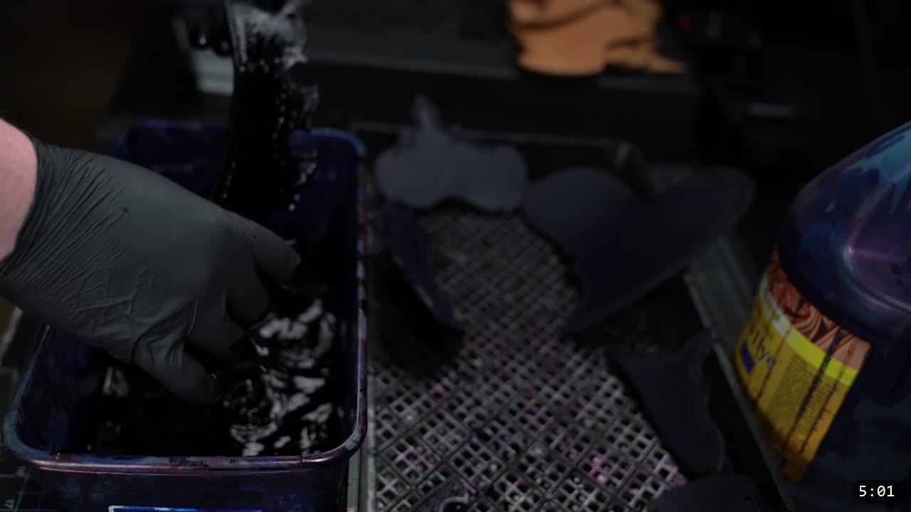Imperial Knight Tassets Build Guide: Leather Hip Armor from a Flat Pattern 8 a gloved hand dyeing cut leather tasset pieces in a dye tray, dyed pieces resting on a drip grate to dry