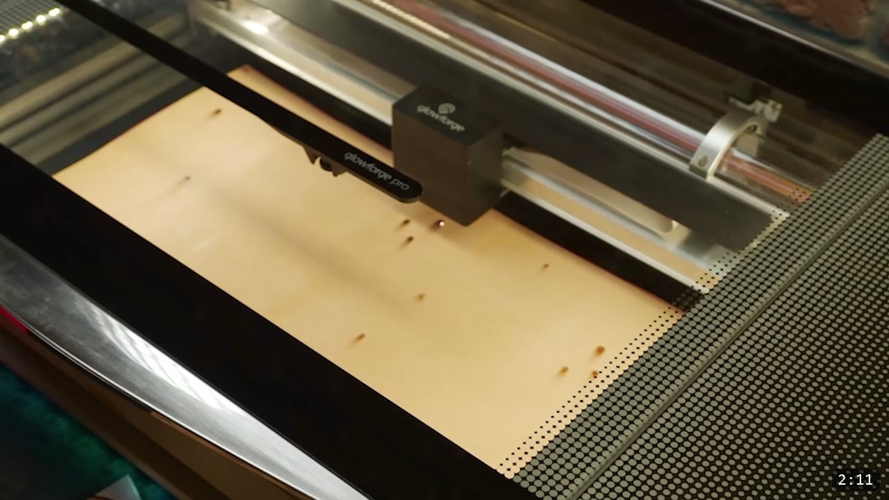 Leather Leg Armor Build Guide: Articulated Cuisses, Knees, and Greaves 2 a Glowforge desktop laser cutter cutting parts from a tan sheet of vegetable-tan leather laid in the honeycomb bed