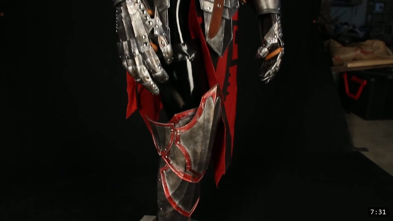 Leather Armor for Beginners: Tools You Need and How to Start 12 a finished red and silver leather knight armor with gauntlets and thigh plates standing on a display