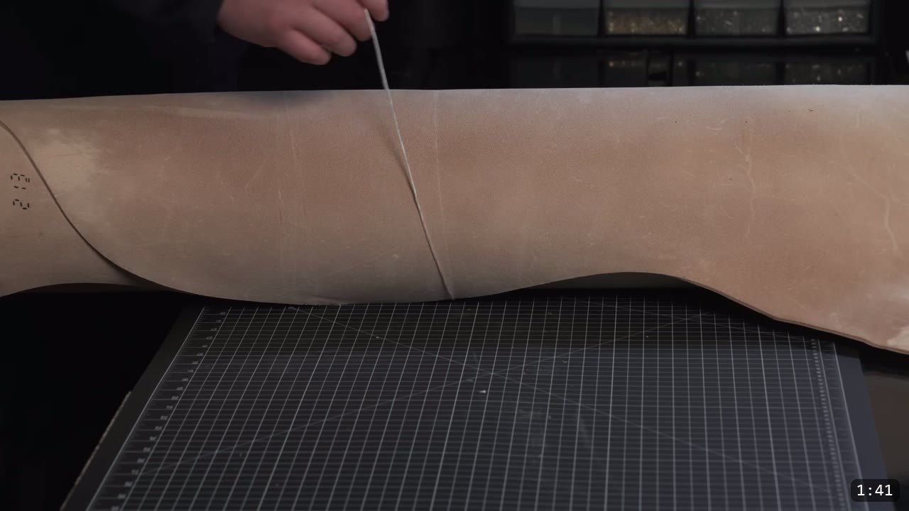 Leather Armor for Beginners: Tools You Need and How to Start 3 a full side of natural vegetable-tan leather draped over the bench, being divided with a utility knife on a black cutting mat