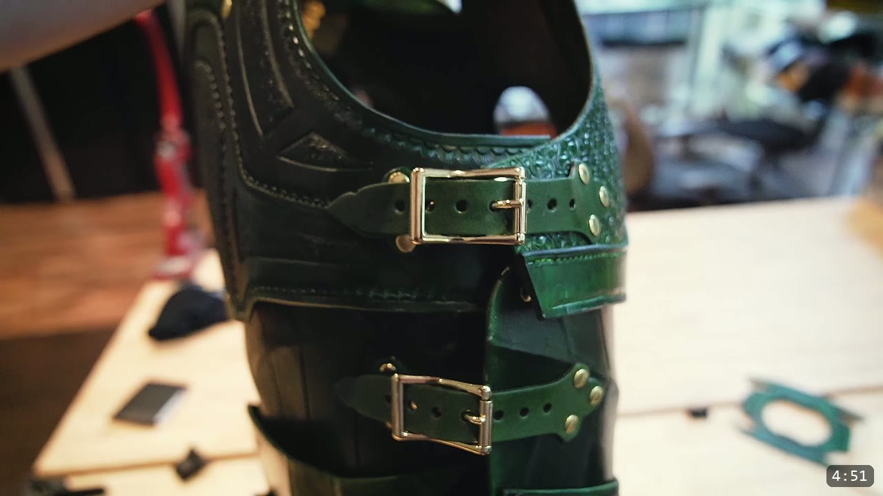 Leather Buckle Straps for Armor: A Reusable How-To with Free Patterns 2 two silver center-bar buckle straps fastening a green tooled leather armor piece with rivets