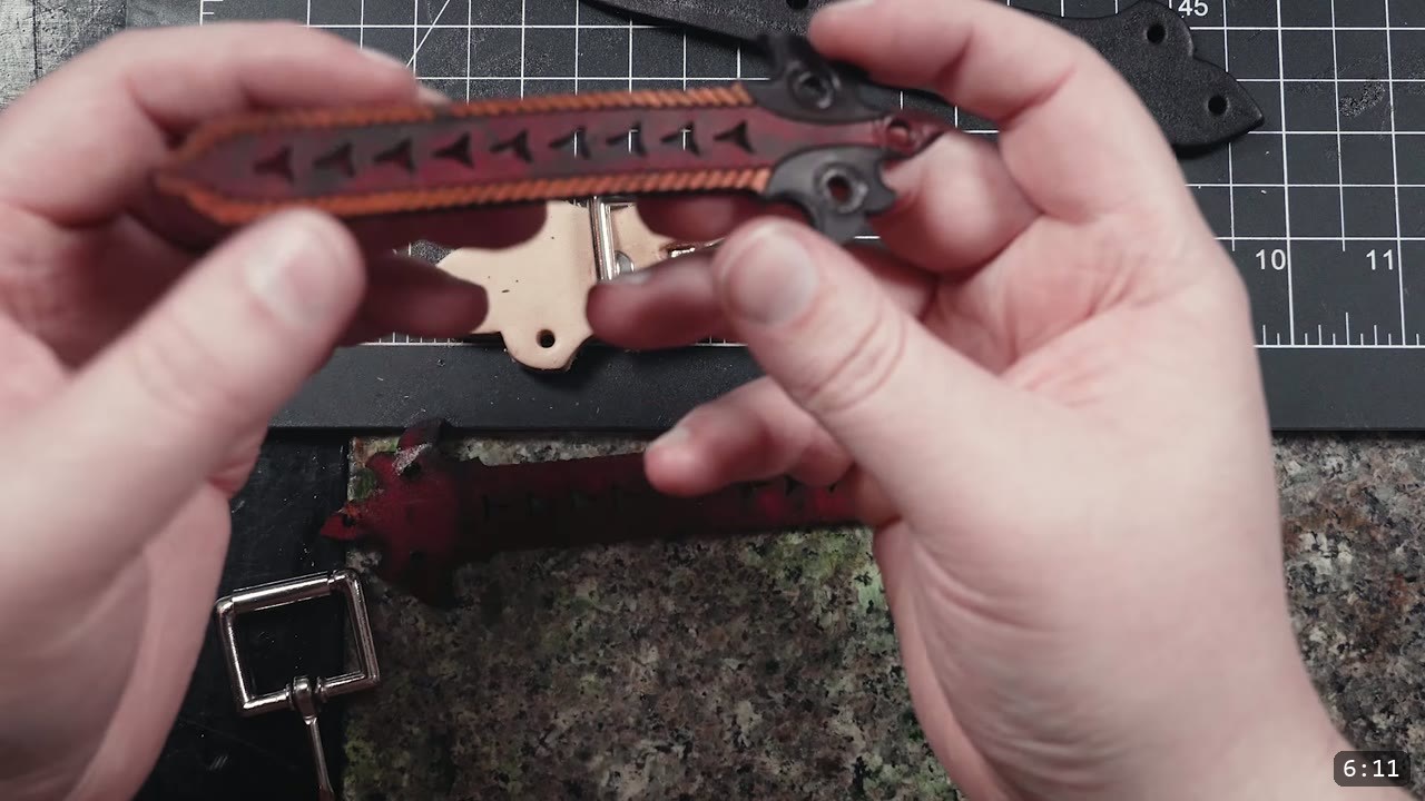 Leather Buckle Straps for Armor: A Reusable How-To with Free Patterns 11 a dark oxblood tooled strap with cut-out triangular design lines and a painted orange edge, joined to a natural leather buckle tab