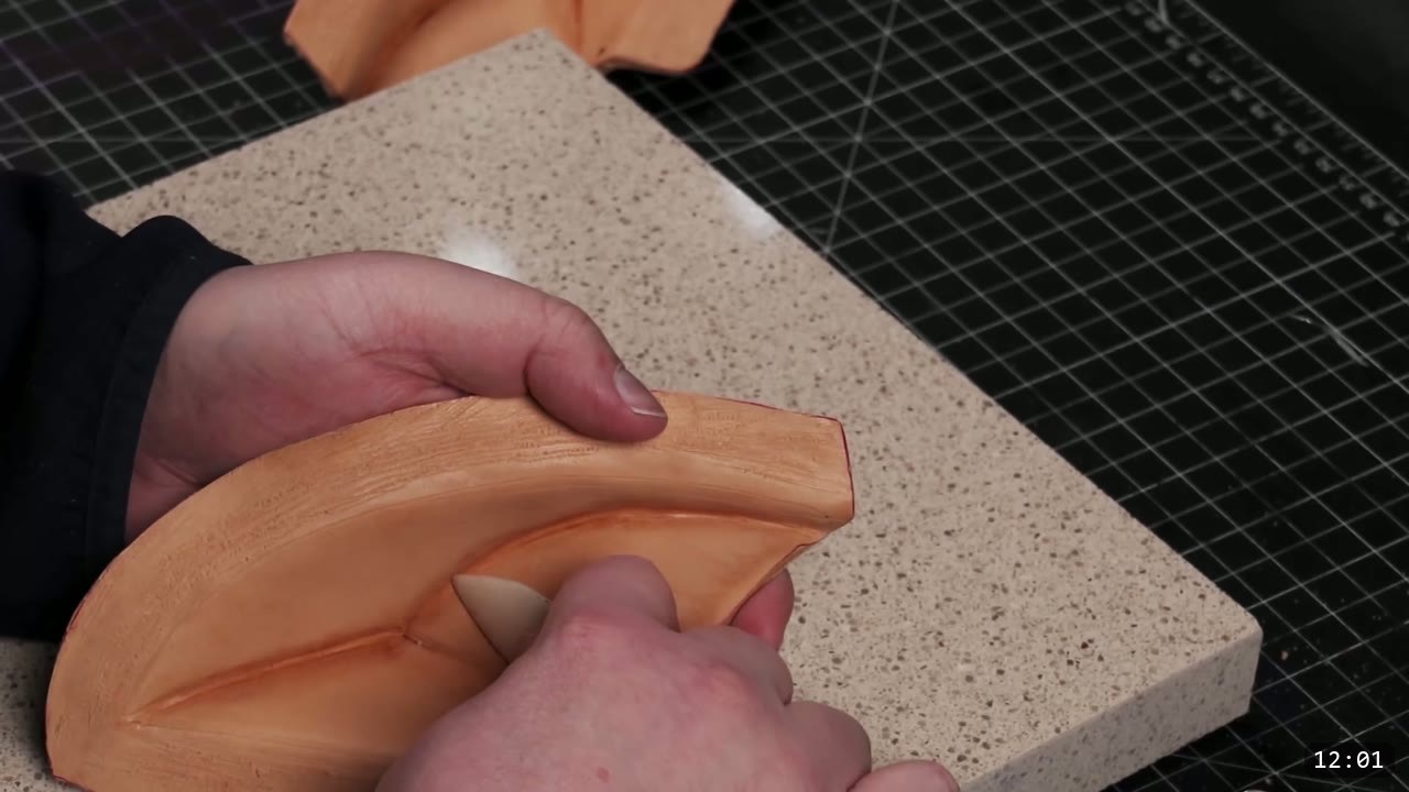 Leather Mandalorian Helmet Build Guide: Flat Pattern to Chrome Finish 8 burnishing the flat planes of a leather helmet piece with a slicking tool to clean up the creases