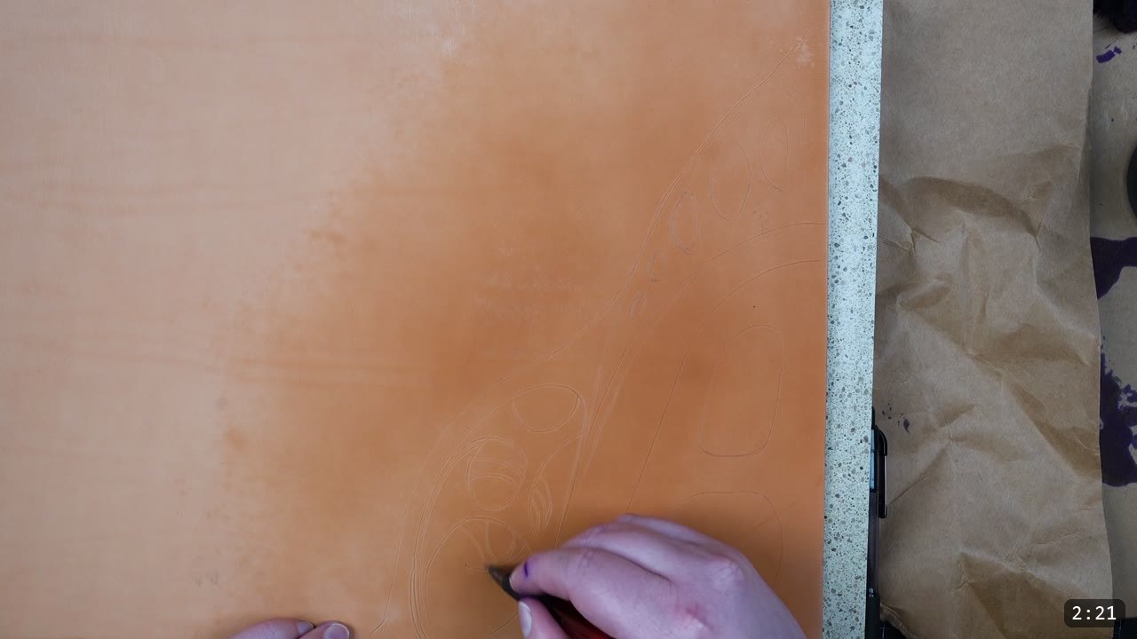 Custom Leather Armor: How I Design, Tool, and Color Test a Suit (Manticore Build) 4 filigree leaf and oval shapes drawn freehand across a natural tan leather test sample to work out the proportions