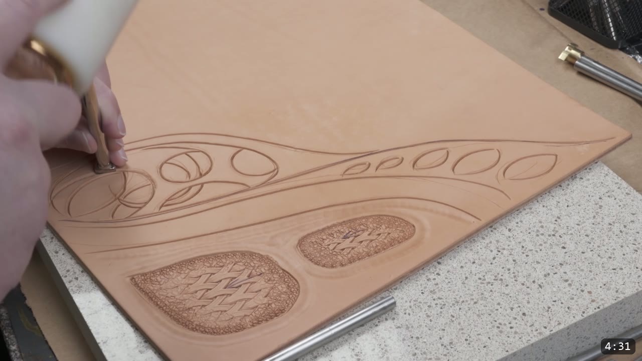 Custom Leather Armor: How I Design, Tool, and Color Test a Suit (Manticore Build) 7 a natural tan leather sample carved with flowing filigree lines and two teardrop pockets filled with a woven basket-weave texture and beaded background
