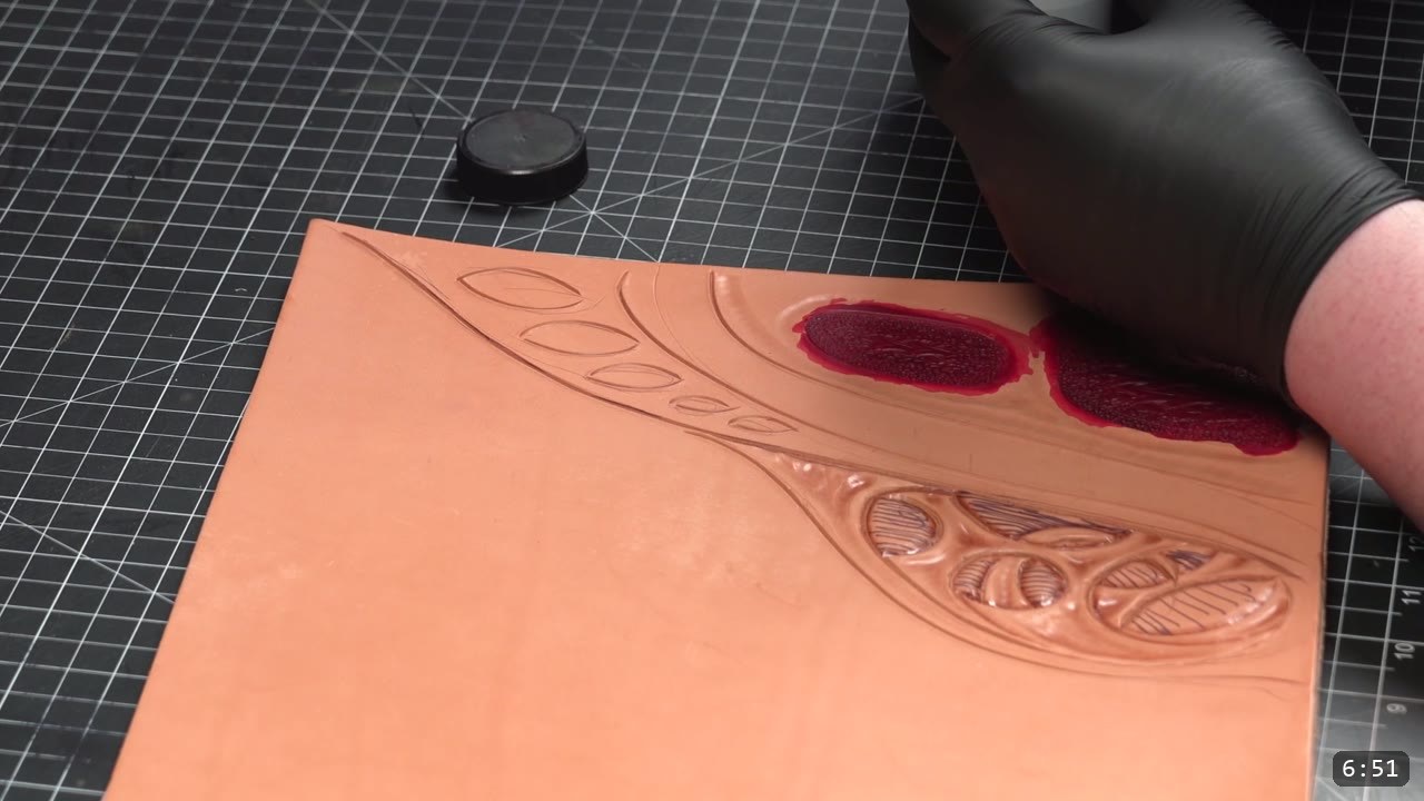 Custom Leather Armor: How I Design, Tool, and Color Test a Suit (Manticore Build) 8 a gloved hand brushing deep red dye into the tooled pockets of the tan sample to test the red accent