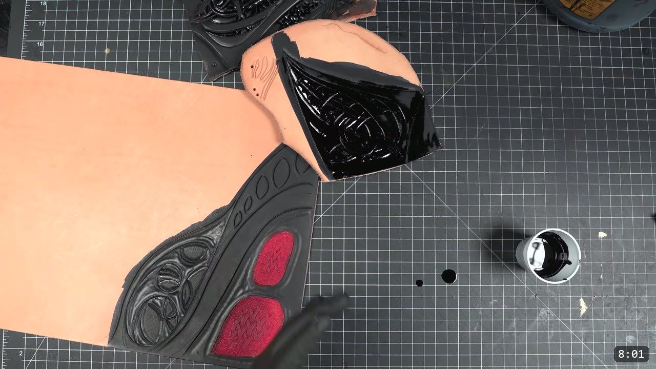 Custom Leather Armor: How I Design, Tool, and Color Test a Suit (Manticore Build) 10 several leather sample panels on a cutting mat, one natural tan, one black with red pockets, and one with wet black dye going on