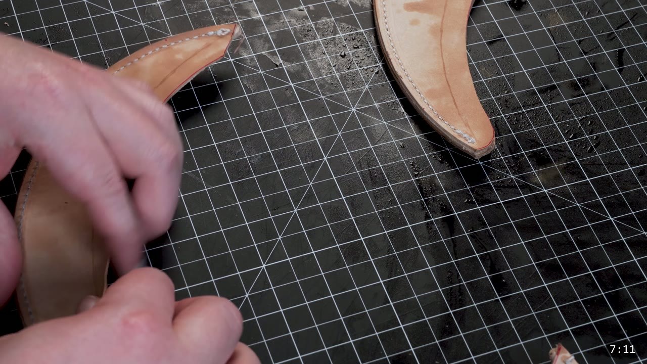The Mountain Leather Helmet Build Guide: A Free Pattern, Start to Finish 8 a stitched, curved crest comb held between fingers with a second finished comb resting on the cutting mat