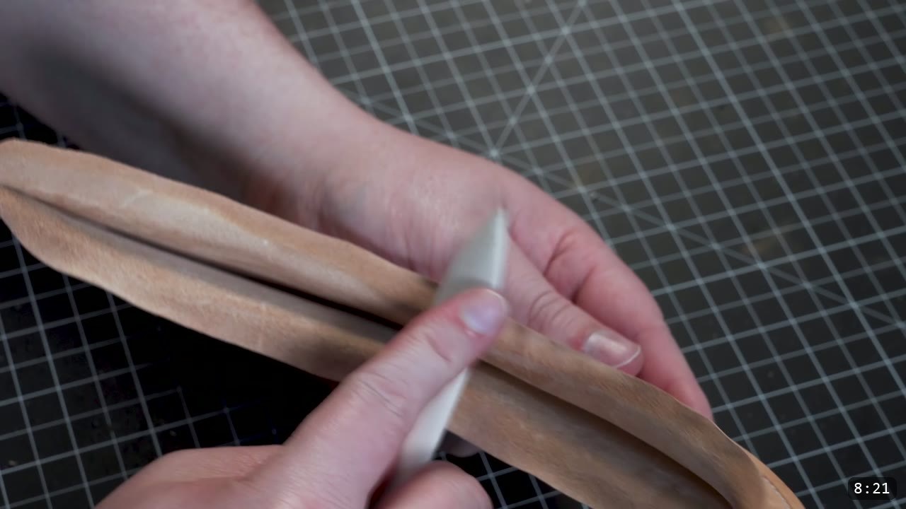 The Mountain Leather Helmet Build Guide: A Free Pattern, Start to Finish 9 creasing and shaping a long curved leather strip with a bone folder on a cutting mat