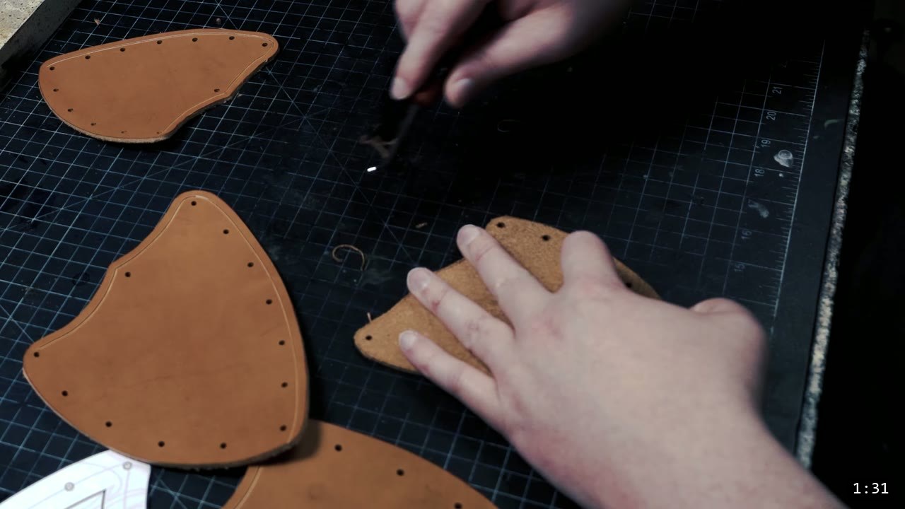 Female Leather Breastplate Build Guide: Warrior Armor from Cups to Buckles 2 pre-cut vegetable-tan Warrior breastplate pieces with punched rivet holes laid out on a cutting mat