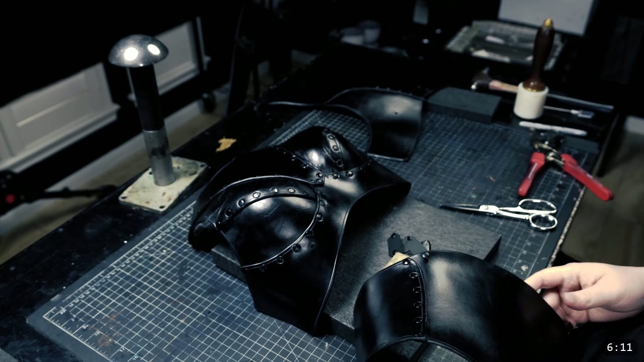 Female Leather Breastplate Build Guide: Warrior Armor from Cups to Buckles 11 the dyed black breastplate front and back panels laid out on the bench after sealing, with a rivet setter and shears nearby