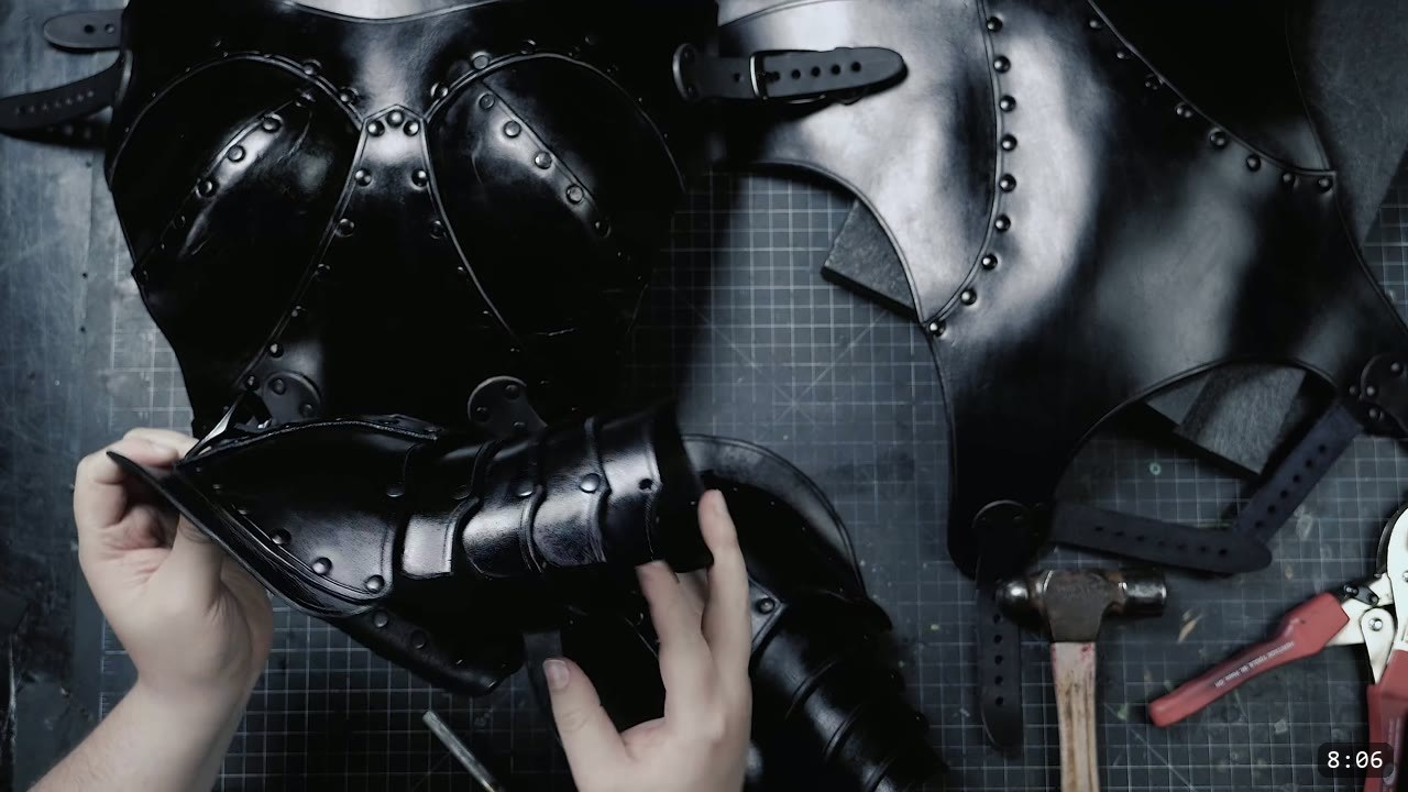 Female Leather Breastplate Build Guide: Warrior Armor from Cups to Buckles 13 the finished black breastplate with a retaining strap joining the top and lower plates, the back panel with buckle straps beside it
